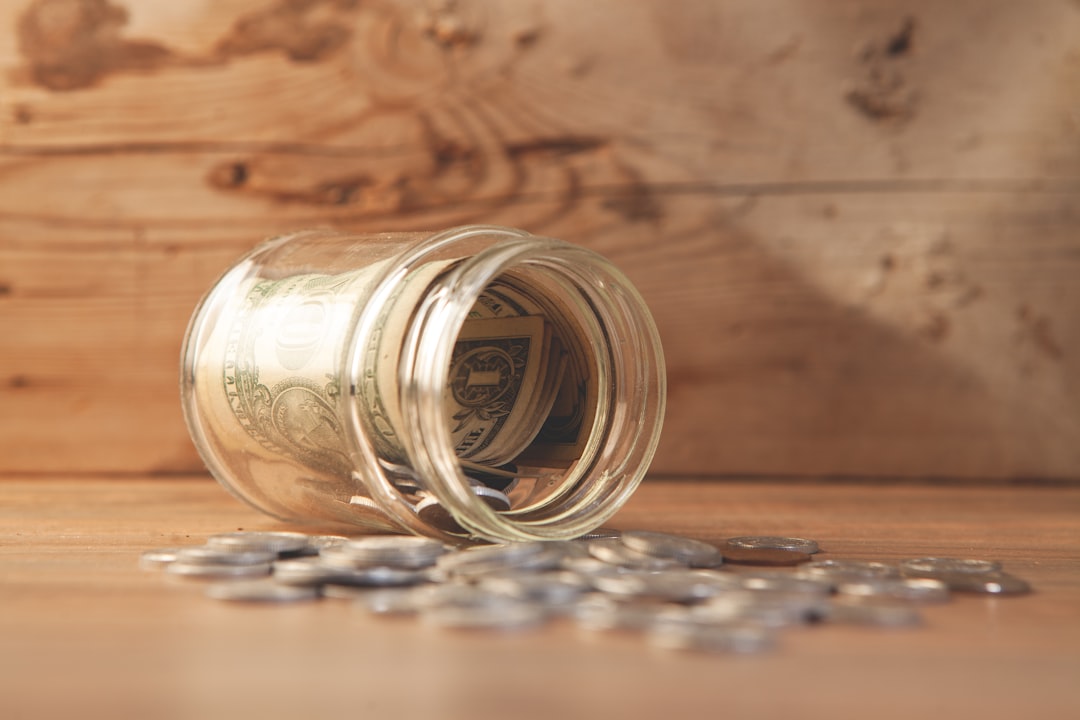 money in glass jar with dollar bills. business concept