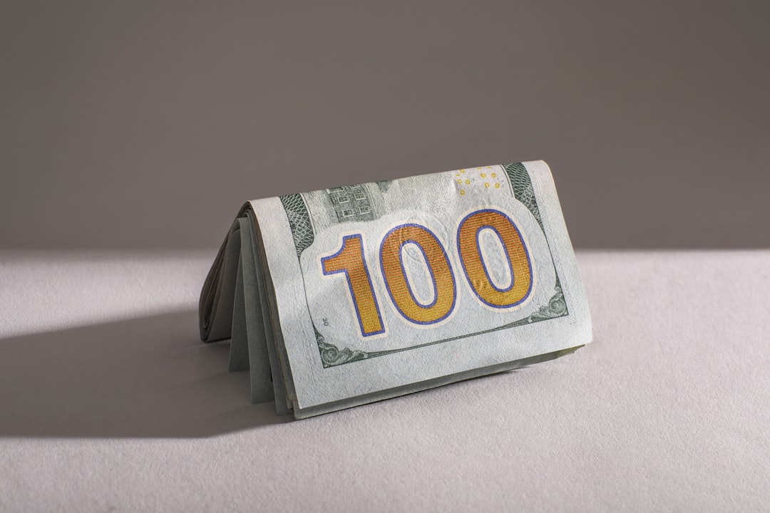 a-stack-of-one-hundred-dollar-bills-eqe2jtzni9i